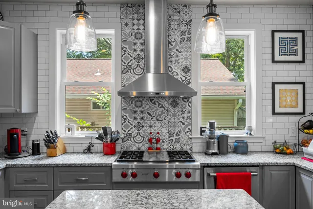 a kitchen with stainless steel appliances kitchen island granite countertop a stove a sink and a microwave