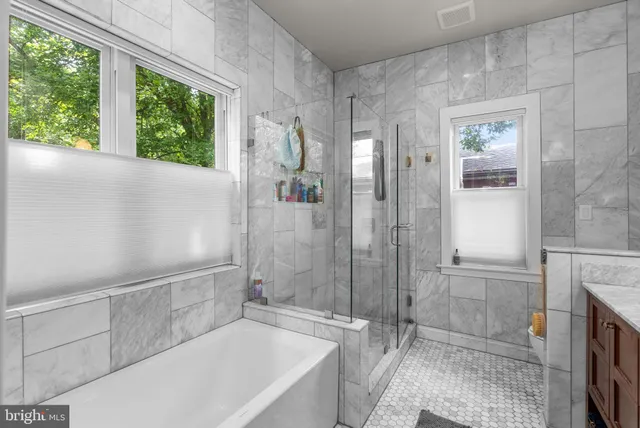 a bathroom with a tub shower and sink