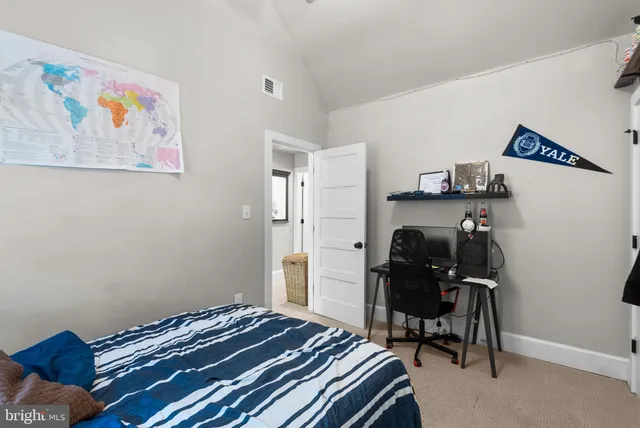 a bedroom with furniture and a piano