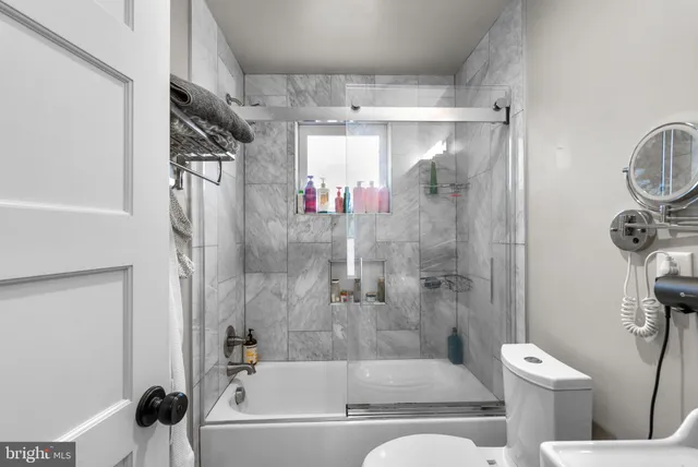 a bathroom with a bathtub and a shower