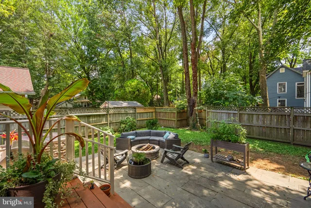 a view of backyard with seating and green space