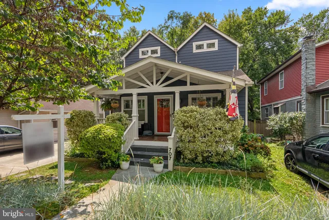 a front view of a house with a yard table and chairs