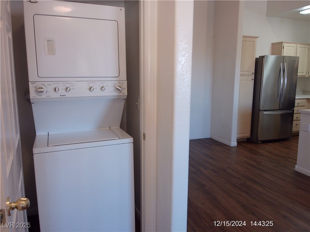 855 North Stephanie Street, Unit 2526 Henderson, NV 89014 - Photo 15 of 26 Laundry area with estacked washer and dryer and dark wood finished floors