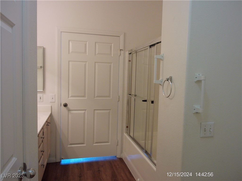 855 North Stephanie Street, Unit 2526 Henderson, NV 89014 - Photo 18 of 26 Full bath with vanity, dark wood-style flooring, and bath / shower combo with glass door