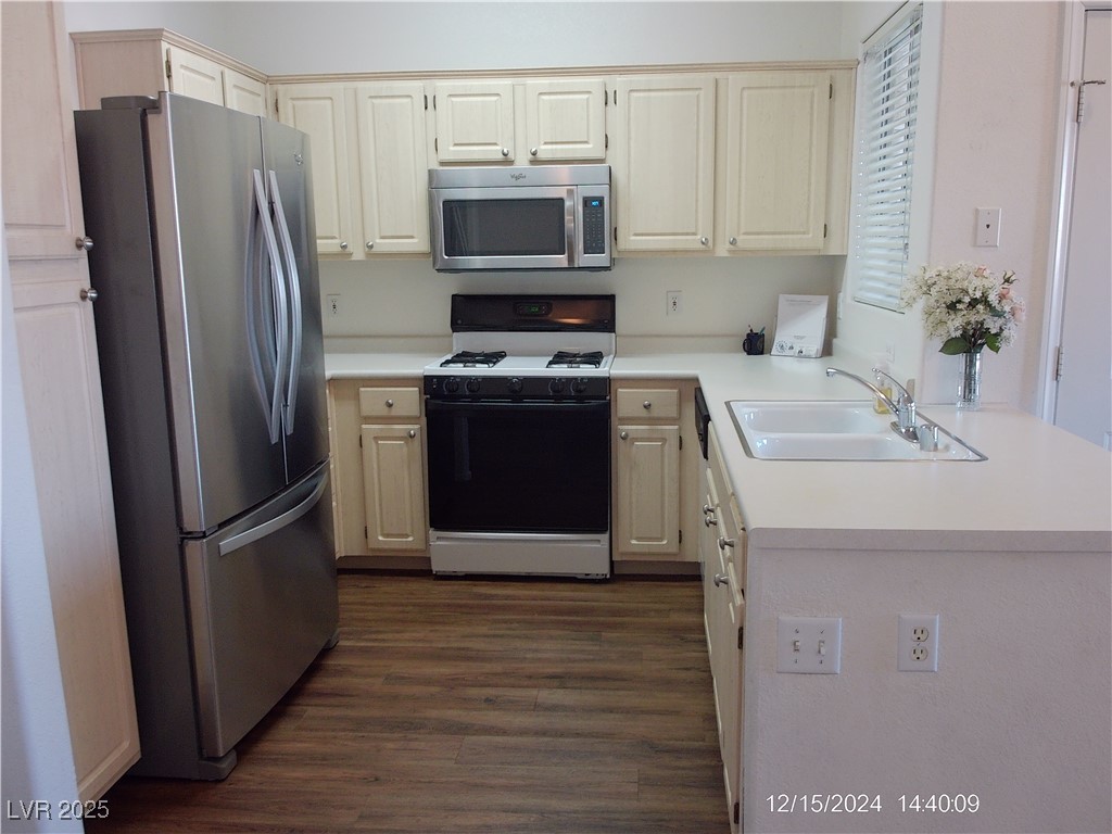 855 North Stephanie Street, Unit 2526 Henderson, NV 89014 - Photo 10 of 26 Kitchen with light countertops, stainless steel appliances, and dark wood finished floors