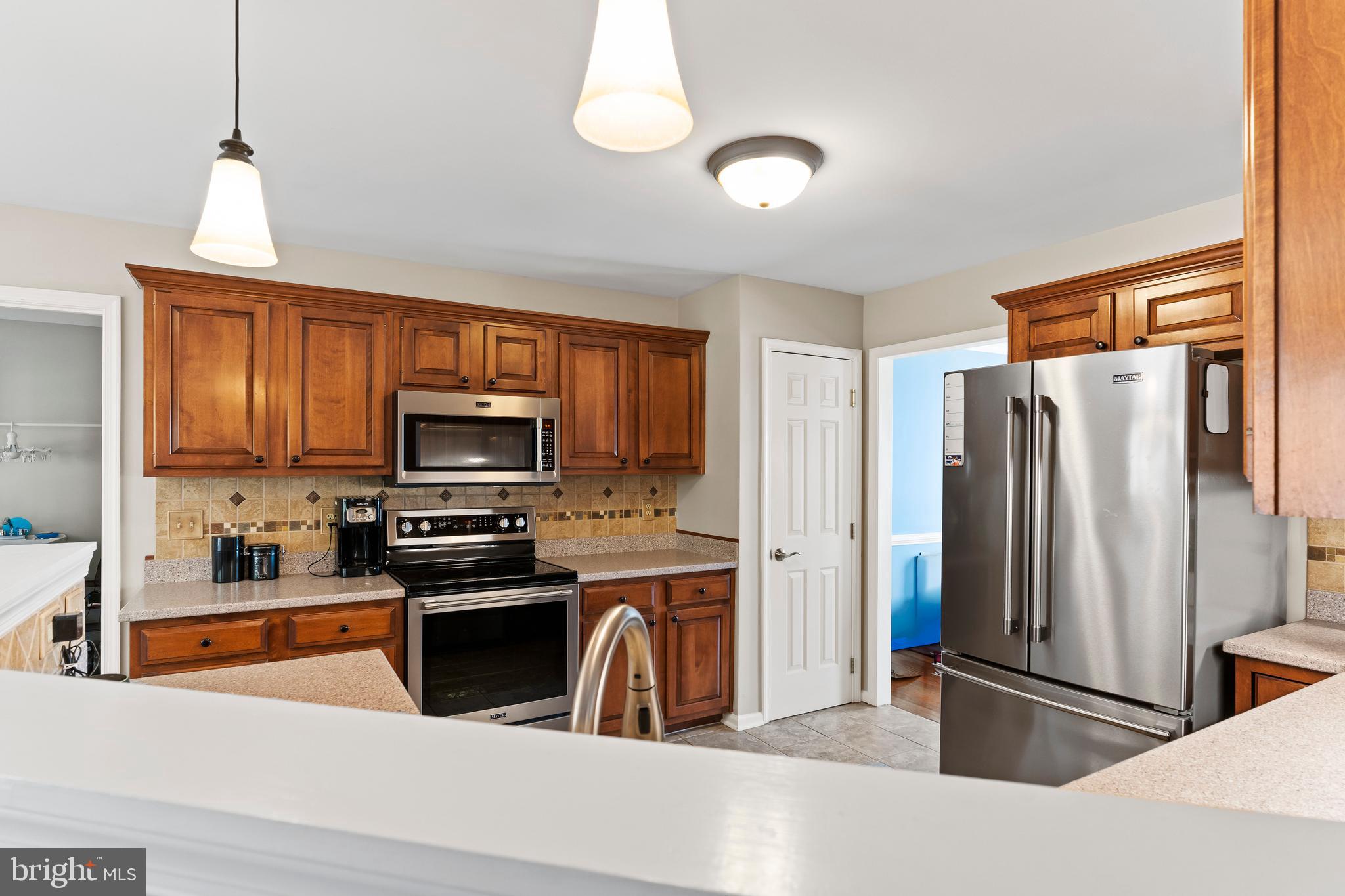 13 Todd Road Carlisle, PA 17013 - Photo 24 of 46 a kitchen with stainless steel appliances granite countertop a refrigerator a stove top oven a sink and dishwasher