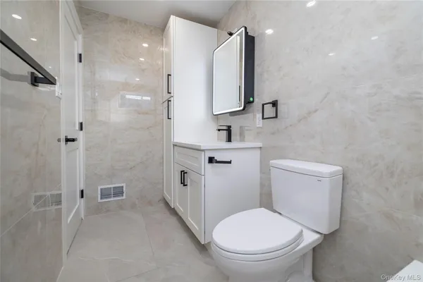 a bathroom with a toilet sink and shower