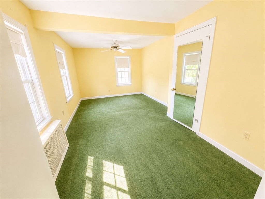 36 Plummer Avenue Lowell, MA 01852 - Photo 18 of 23 a view of a big room with windows and chandelier