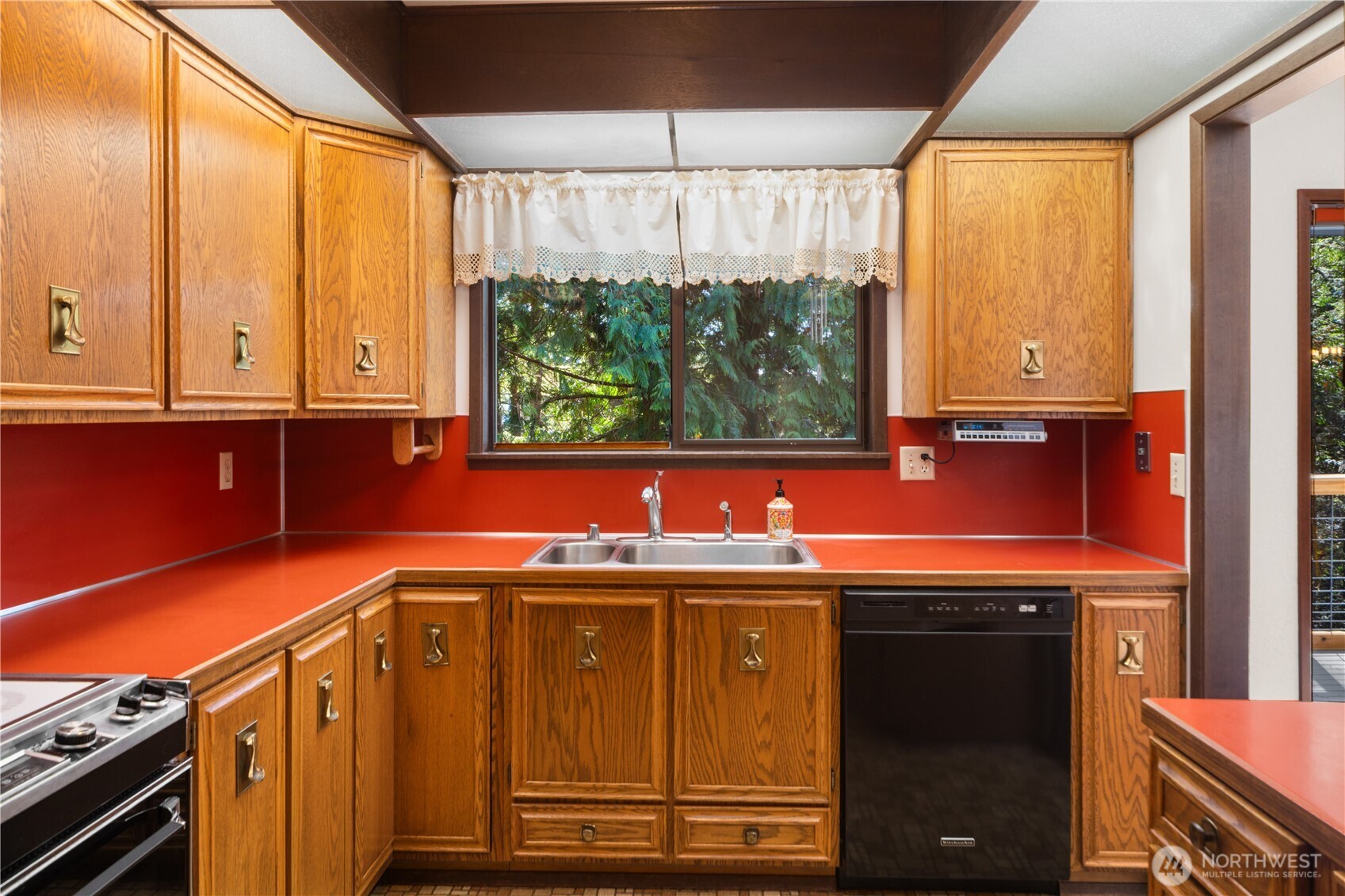 91 Drew Lane Port Ludlow, WA 98365 - Photo 11 of 38 a view of a kitchen with wooden floor and a window