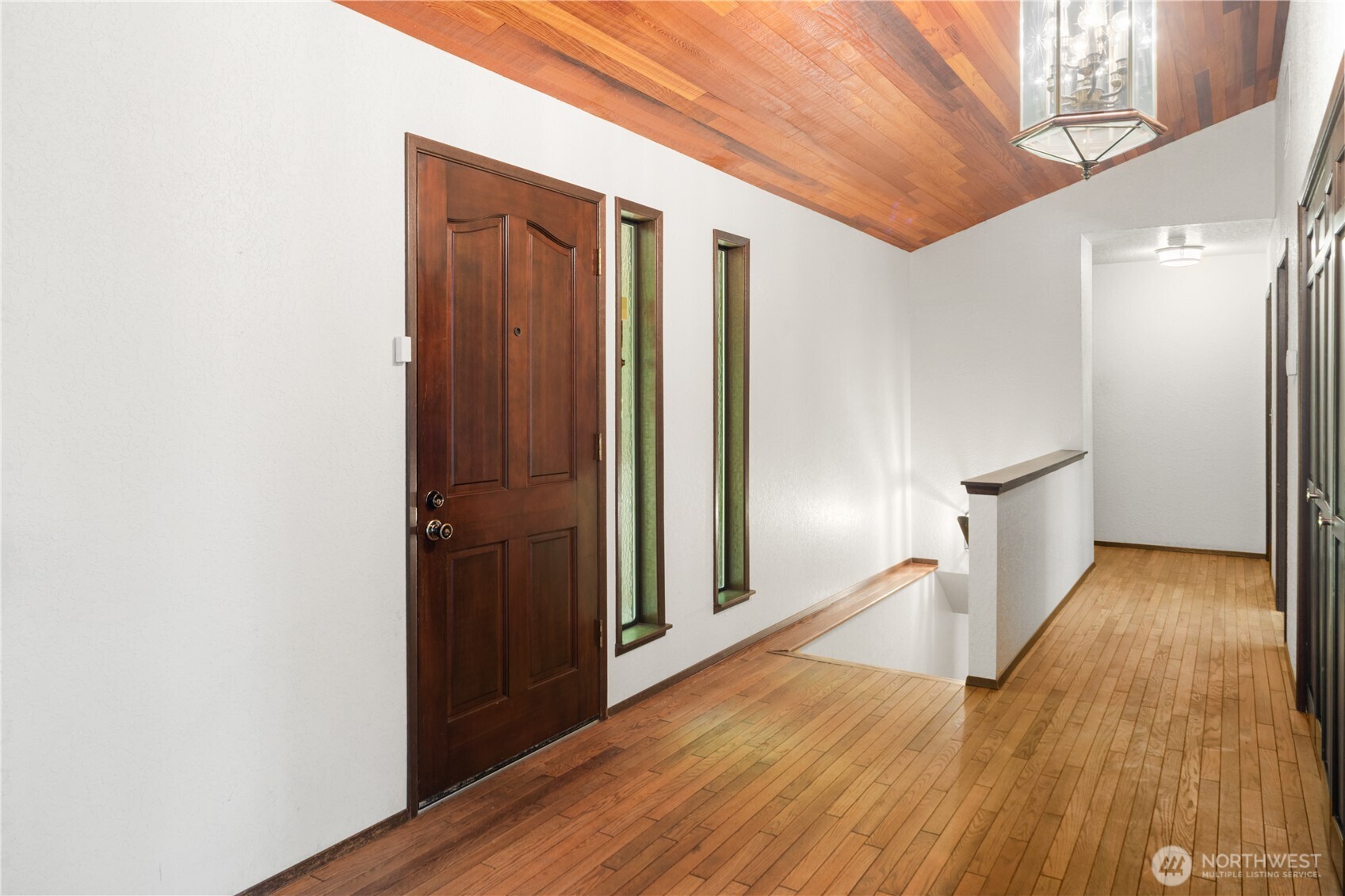 91 Drew Lane Port Ludlow, WA 98365 - Photo 14 of 38 a view of a hallway with wooden floor and staircase