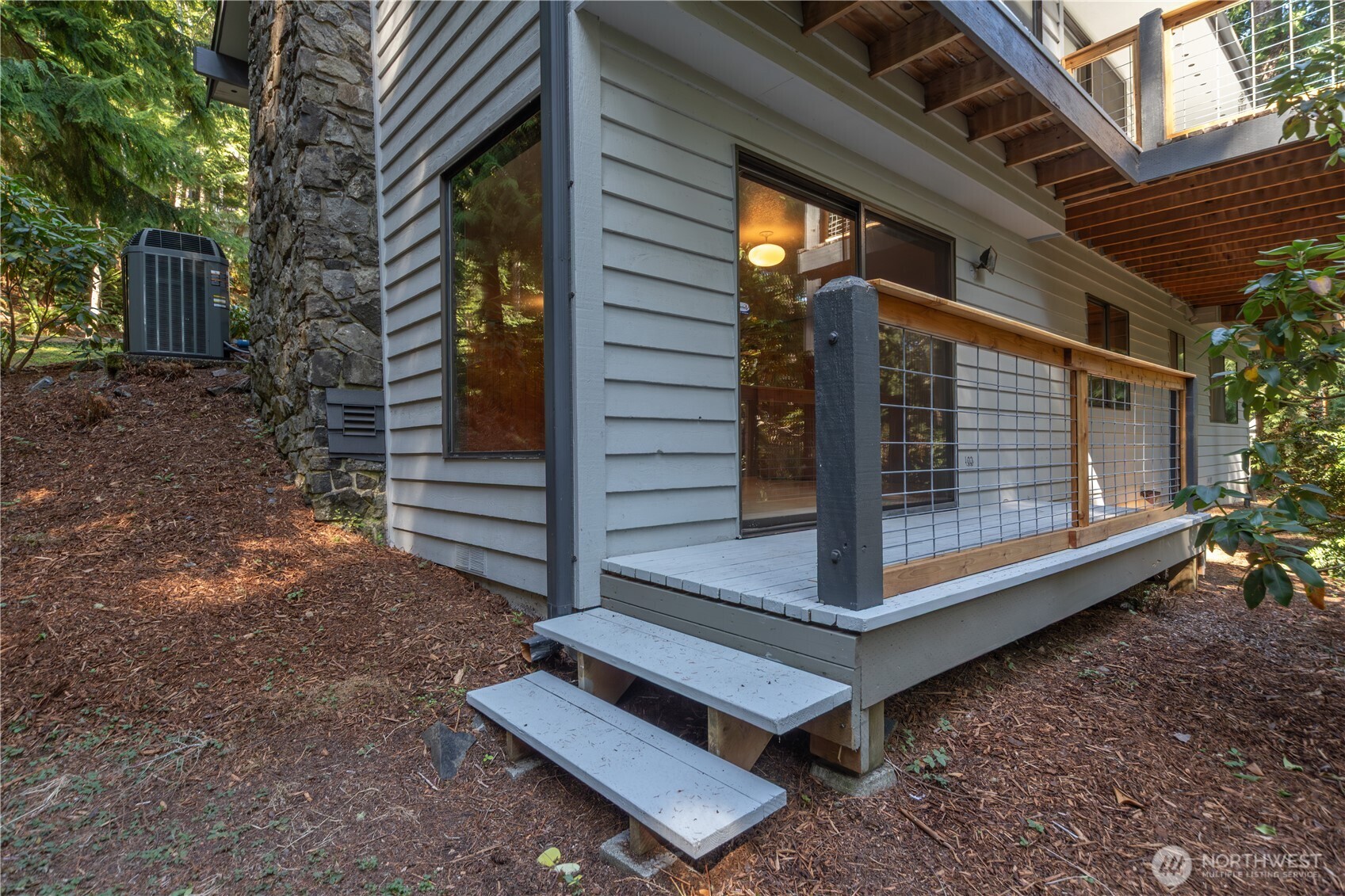 91 Drew Lane Port Ludlow, WA 98365 - Photo 33 of 38 a view of backyard with wooden fence and a bench