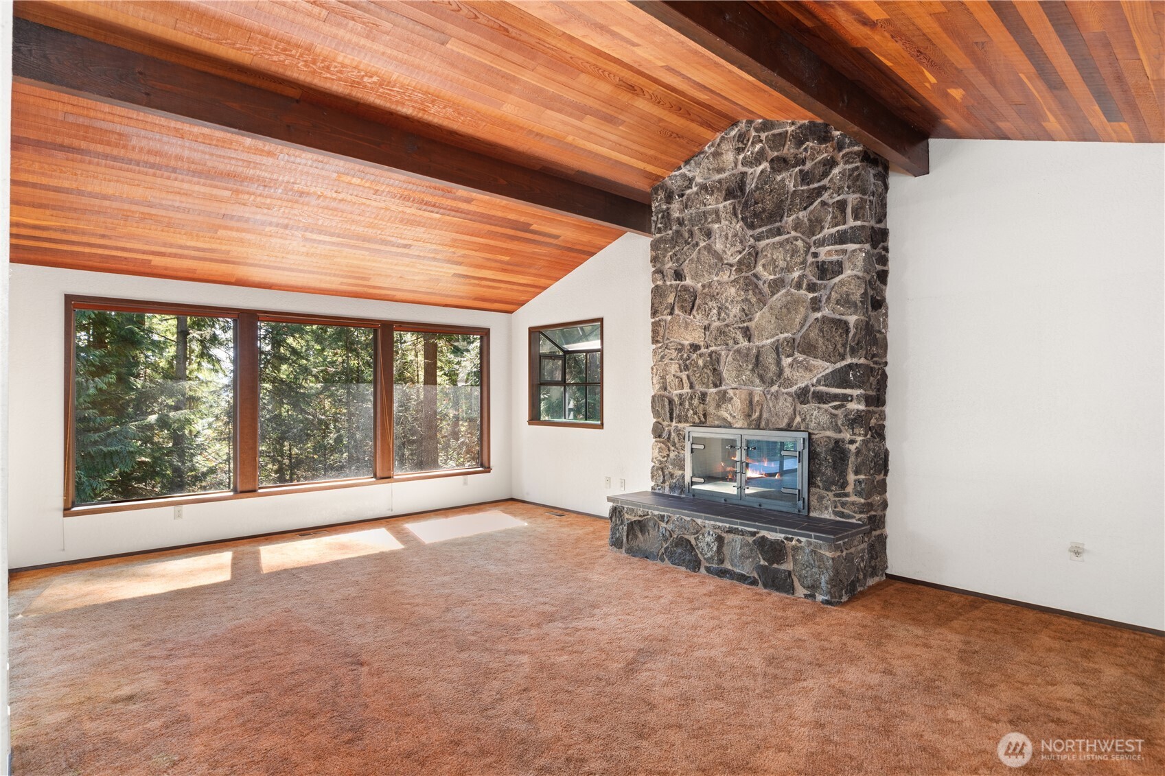 91 Drew Lane Port Ludlow, WA 98365 - Photo 5 of 38 a view of an empty room with a fireplace and a window