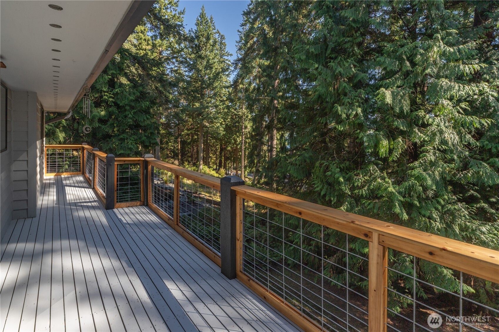 91 Drew Lane Port Ludlow, WA 98365 - Photo 10 of 38 a balcony with wooden floor and trees