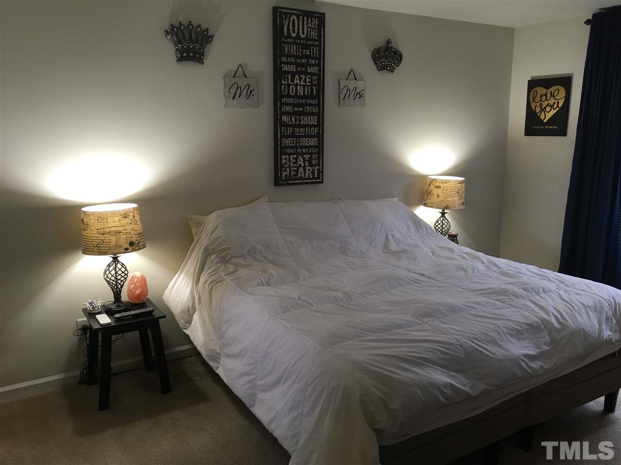 641 Hastings Road Mebane, NC 27302 - Photo 9 of 23 a bedroom with a bed and a lamp on table