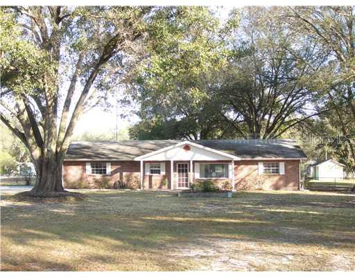 1025 Thomas Road Lakeland, FL 33809 - Photo 1 of 1 a front view of a house with a large tree