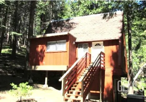 a view of a house with a tree in the background