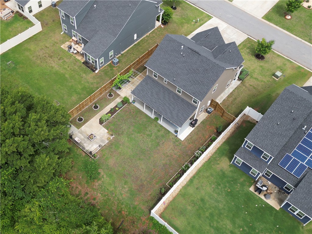 224 Bronson Ridge Anderson, SC 29621 - Photo 39 of 42 An aerial view captures the meticulously maintained grounds, featuring a patio with a fire pit and a charming garden area.