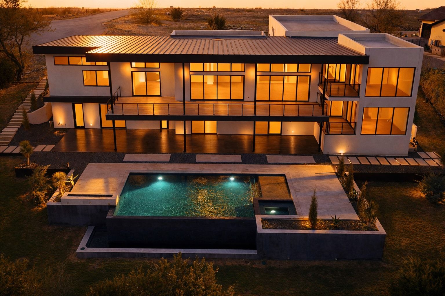 Back of property at dusk featuring a patio area, a metal roof, and a pool with connected hot tub