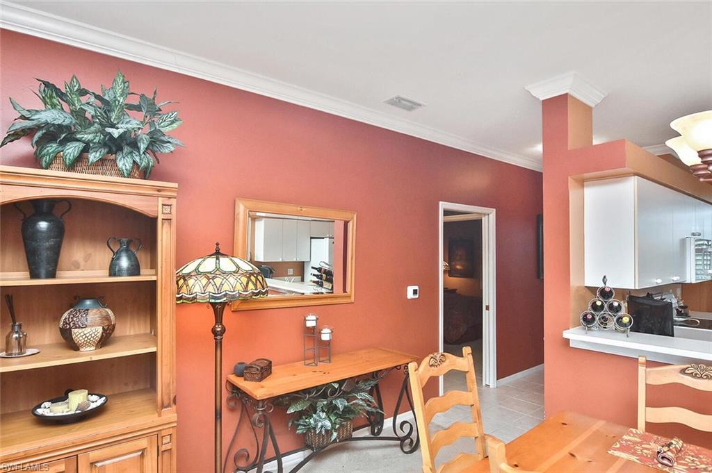 3800 Sawgrass Way, Unit 3143 Naples, FL 34112 - Photo 11 of 45 Dining space featuring crown molding