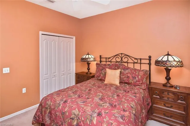 a bedroom with a dresser and a chandelier
