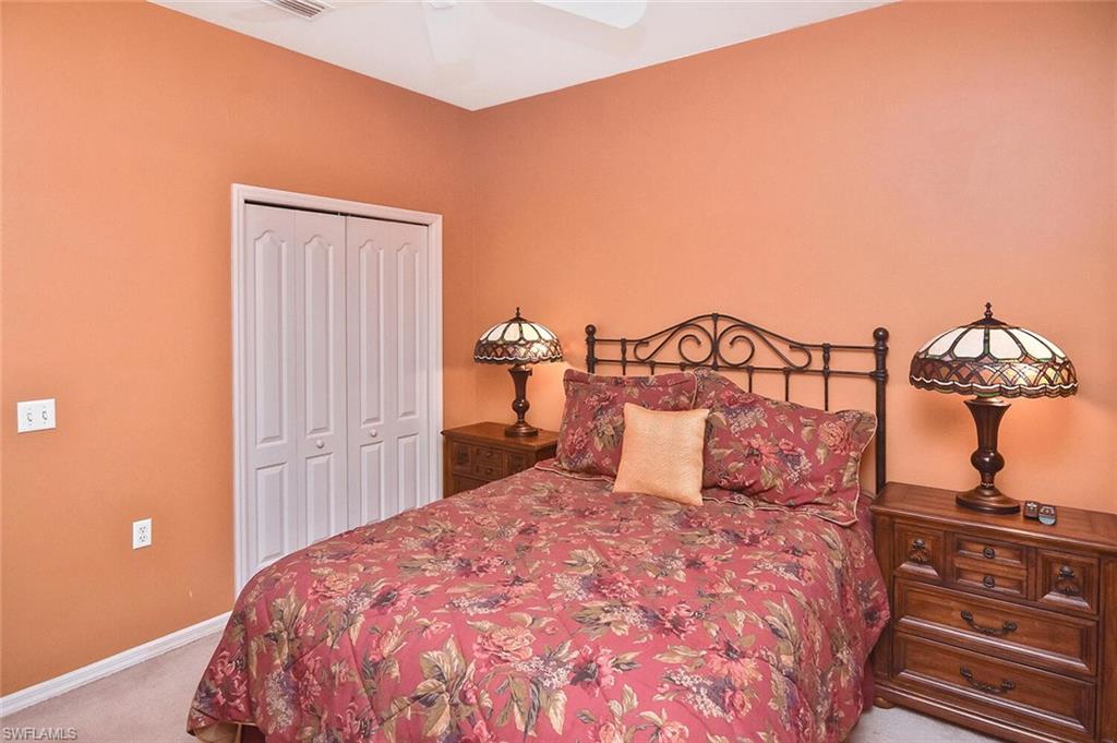 3800 Sawgrass Way, Unit 3143 Naples, FL 34112 - Photo 13 of 45 Bedroom featuring light carpet, a closet, and a ceiling fan