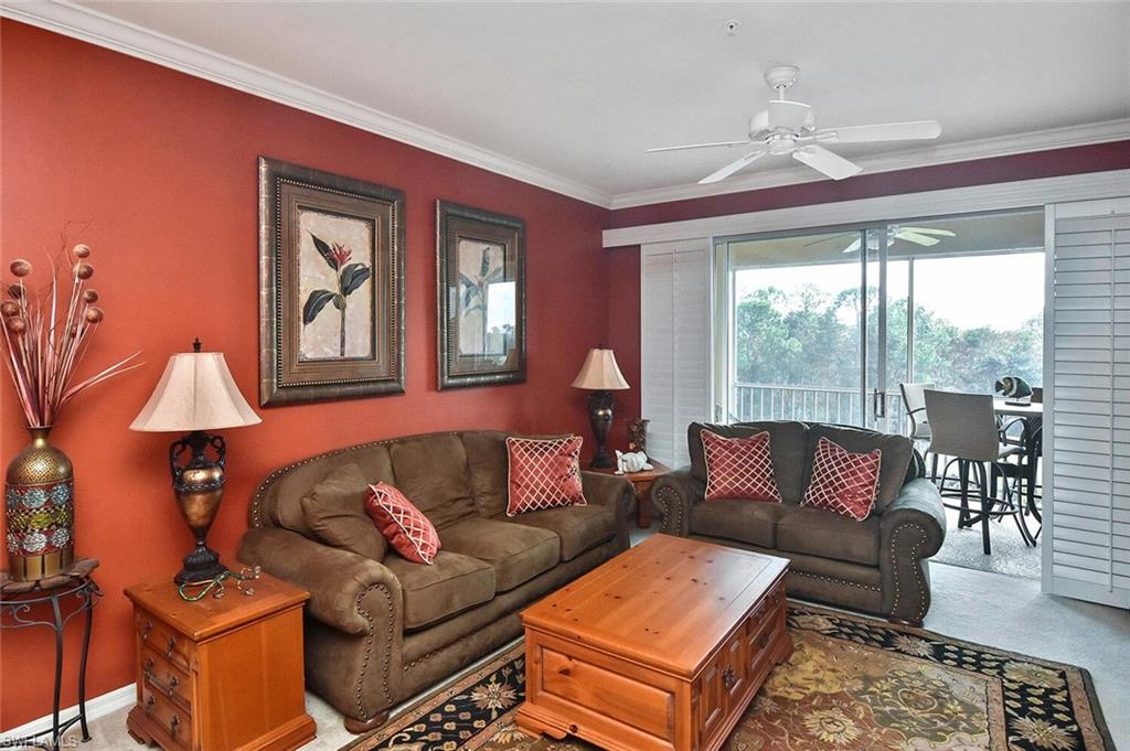 3800 Sawgrass Way, Unit 3143 Naples, FL 34112 - Photo 17 of 45 Carpeted living room with ornamental molding and ceiling fan