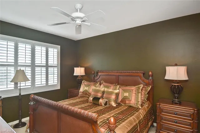 a bedroom with a large bed and a large mirror