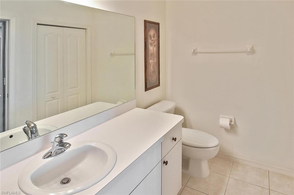 3800 Sawgrass Way, Unit 3143 Naples, FL 34112 - Photo 21 of 45 Bathroom with vanity, light tile patterned floors, and a closet