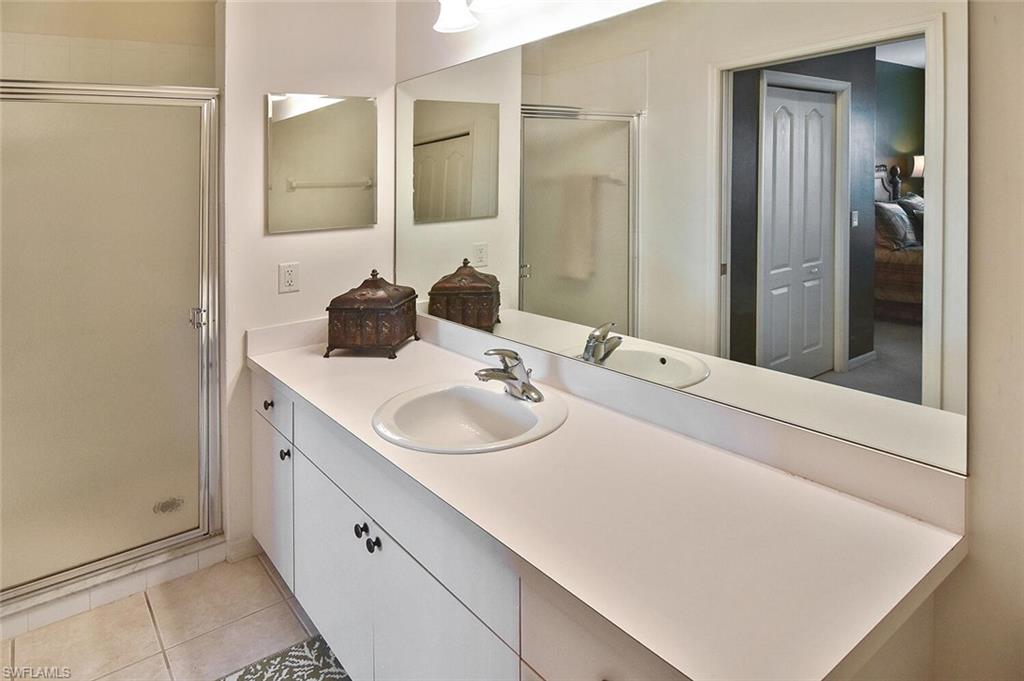 3800 Sawgrass Way, Unit 3143 Naples, FL 34112 - Photo 22 of 45 Full bath featuring a shower stall, vanity, and light tile patterned flooring