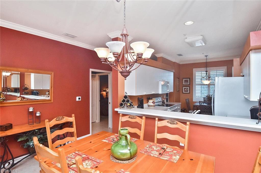 3800 Sawgrass Way, Unit 3143 Naples, FL 34112 - Photo 26 of 45 Dining room featuring a chandelier, crown molding, light wood-type flooring, and recessed lighting