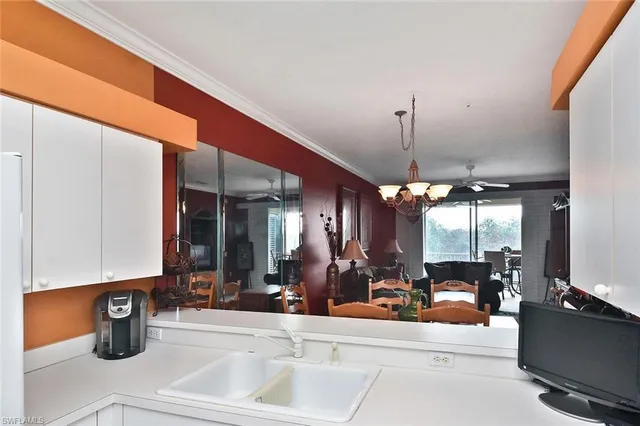 a bedroom with a bed and chandelier