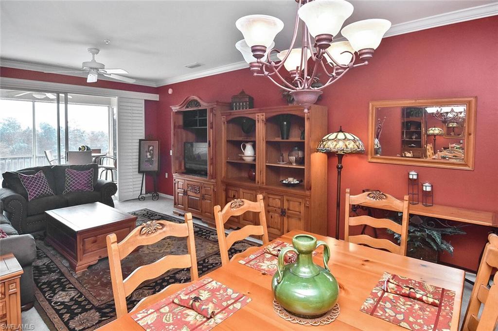 3800 Sawgrass Way, Unit 3143 Naples, FL 34112 - Photo 34 of 45 Dining room with crown molding, a chandelier, and a ceiling fan
