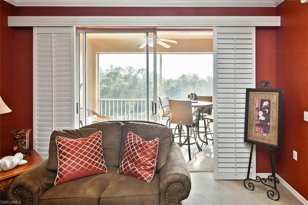 3800 Sawgrass Way, Unit 3143 Naples, FL 34112 - Photo 35 of 45 Living room with carpet floors, a ceiling fan, and crown molding