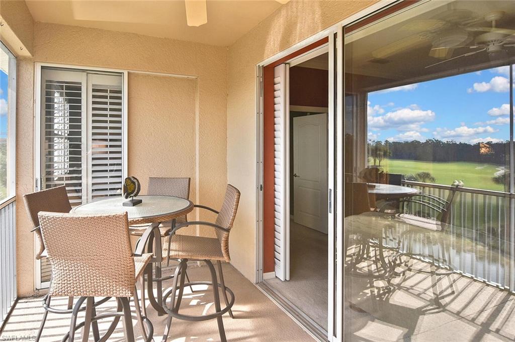 3800 Sawgrass Way, Unit 3143 Naples, FL 34112 - Photo 38 of 45 Balcony with ceiling fan, outdoor dining space, and view of golf course
