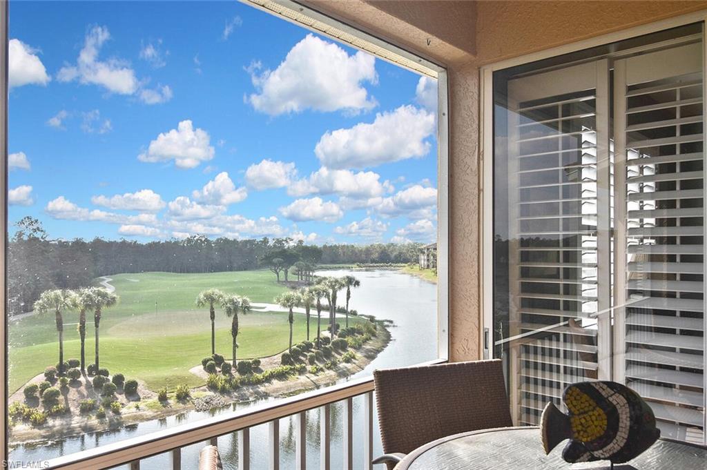 3800 Sawgrass Way, Unit 3143 Naples, FL 34112 - Photo 39 of 45 Balcony featuring golf course view, a water view, and view of wooded area
