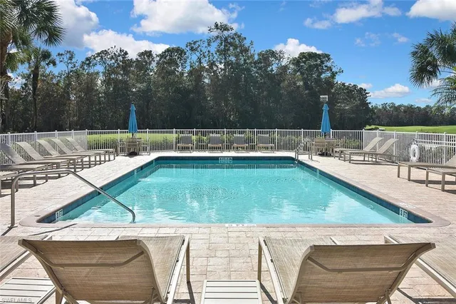 a view of a swimming pool with a lounge chair