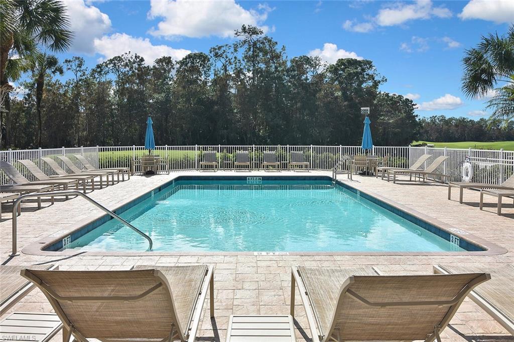 3800 Sawgrass Way, Unit 3143 Naples, FL 34112 - Photo 44 of 45 Community pool with a patio and view of wooded area