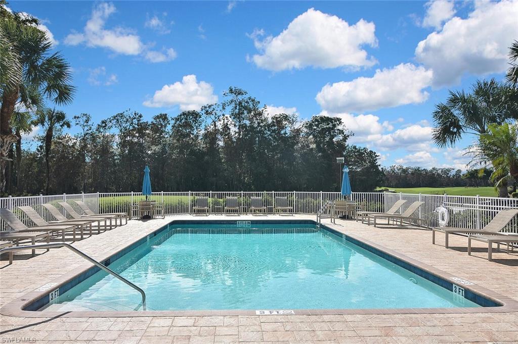 3800 Sawgrass Way, Unit 3143 Naples, FL 34112 - Photo 45 of 45 Community pool with a patio area and view of scattered trees