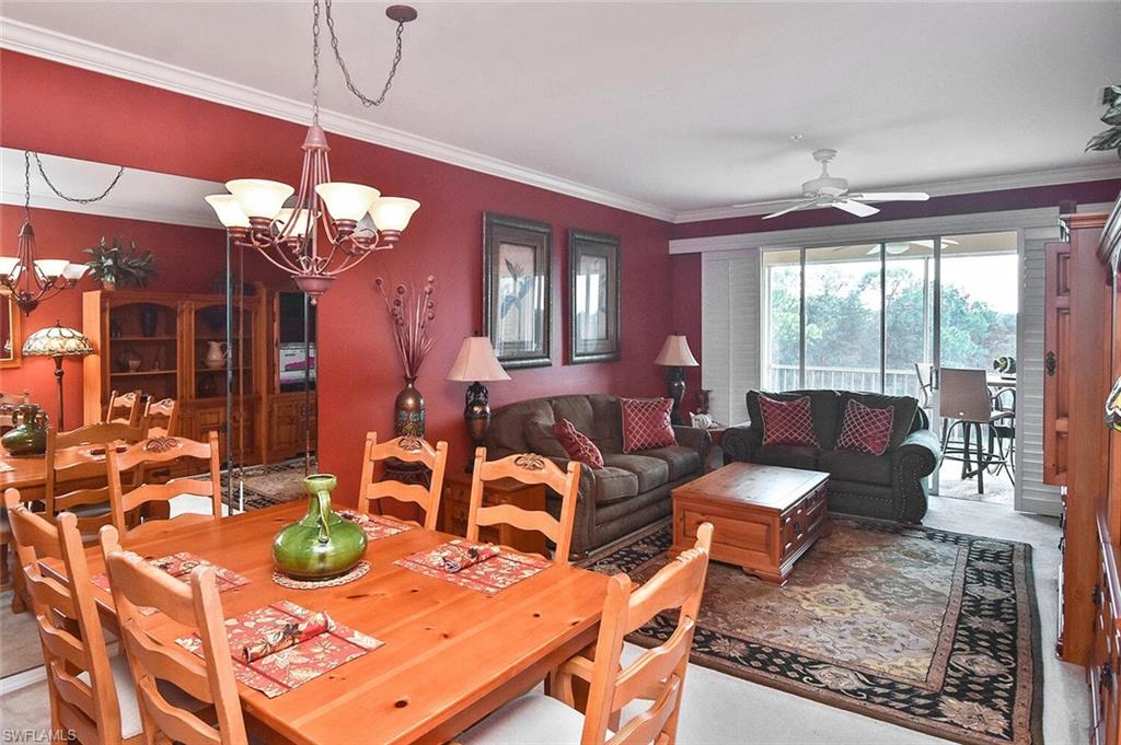 3800 Sawgrass Way, Unit 3143 Naples, FL 34112 - Photo 8 of 45 Dining space featuring ornamental molding, light colored carpet, a chandelier, and ceiling fan