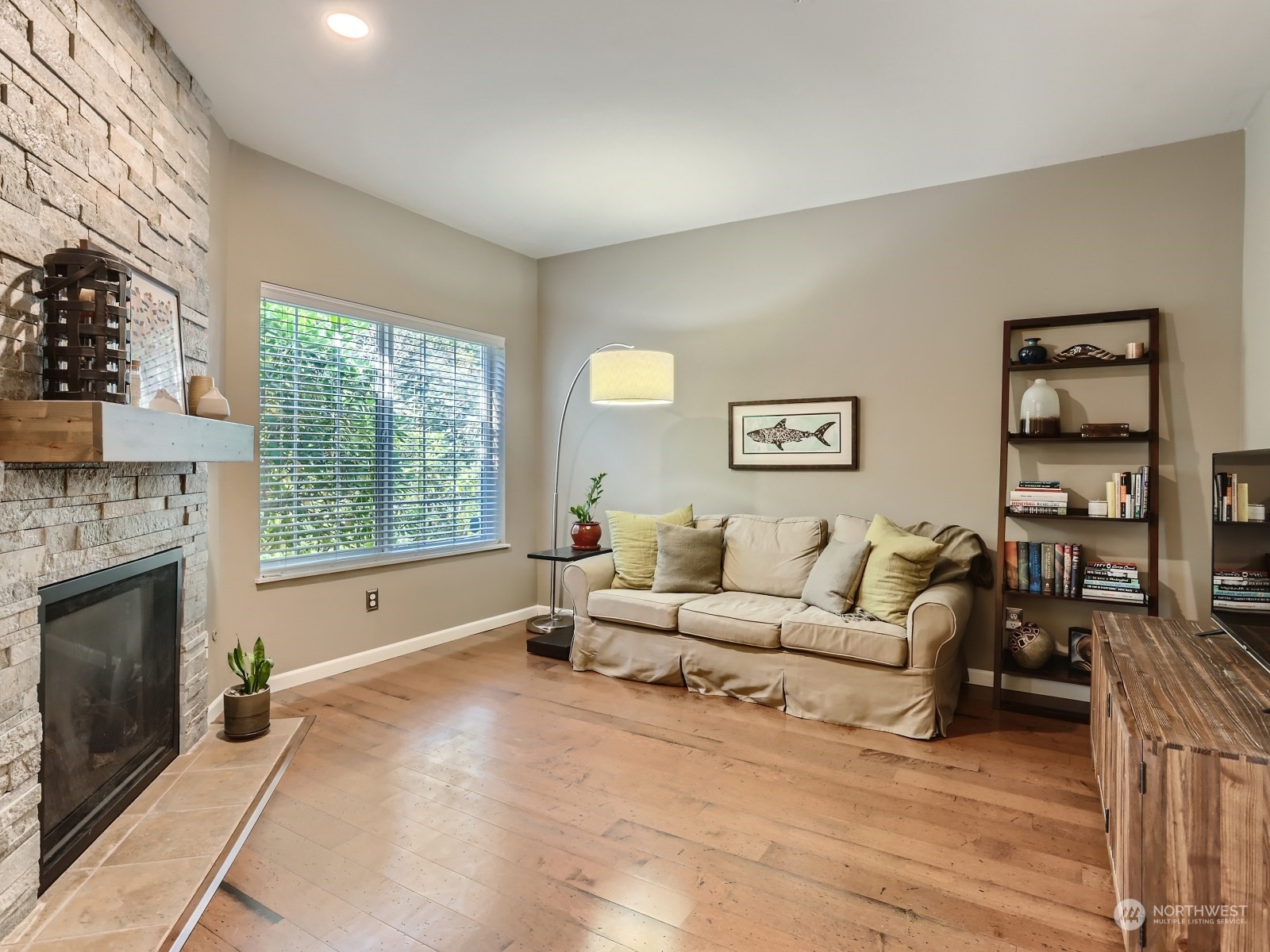 12109 Northeast 171st Place, Unit B101 Bothell, WA 98011 - Photo 1 of 25 a living room with furniture and a fireplace