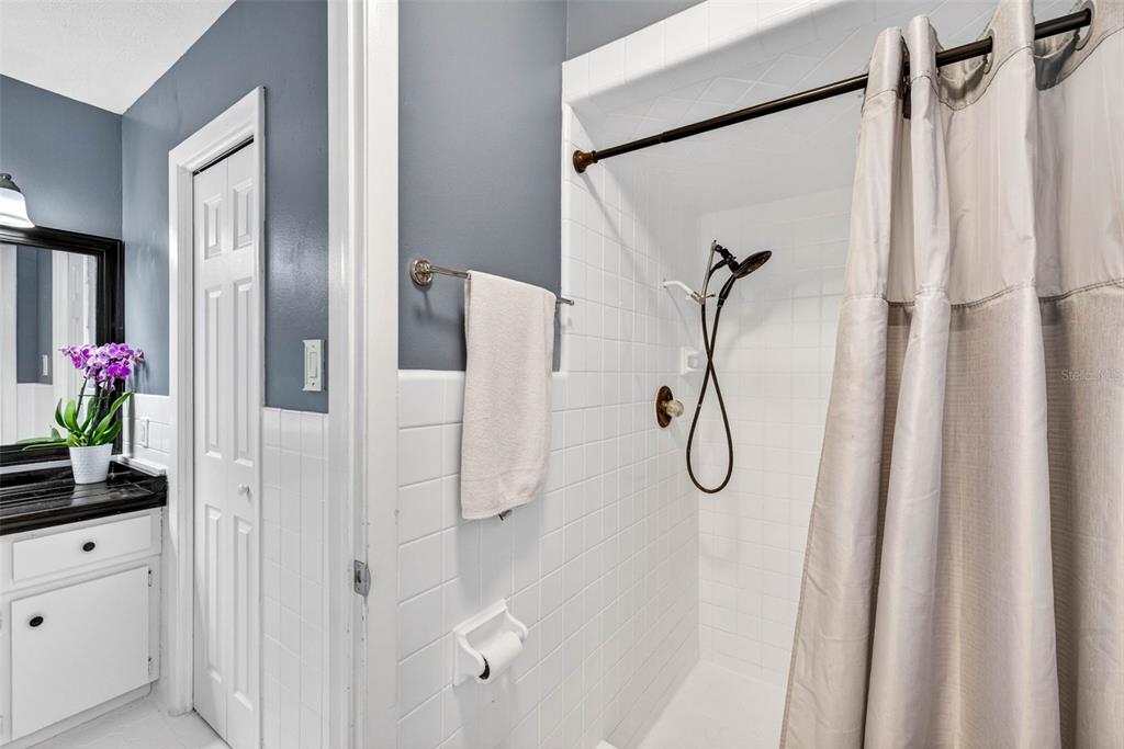 16330 Hanna Road Lutz, FL 33549 - Photo 25 of 41 a bathroom with a shower curtain