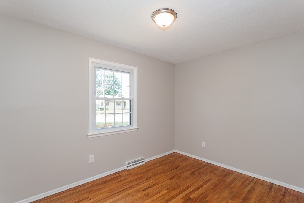 99 Sunnybrook Road Springfield, MA 01119 - Photo 15 of 30 an empty room with wooden floor and windows