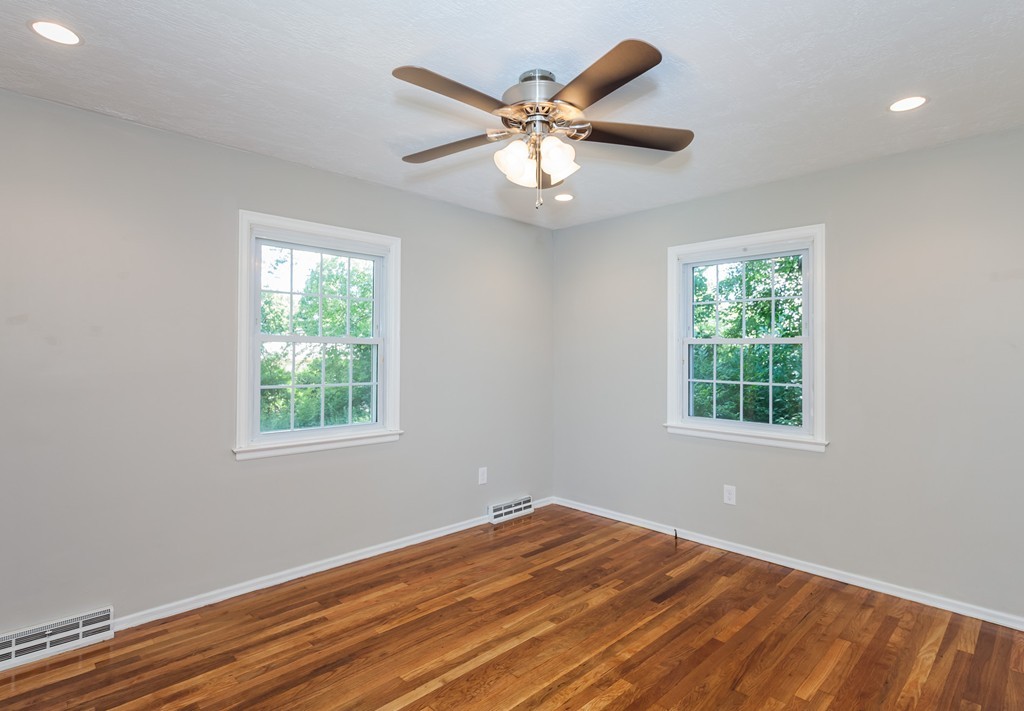 99 Sunnybrook Road Springfield, MA 01119 - Photo 17 of 30 an empty room with wooden floor fan and windows