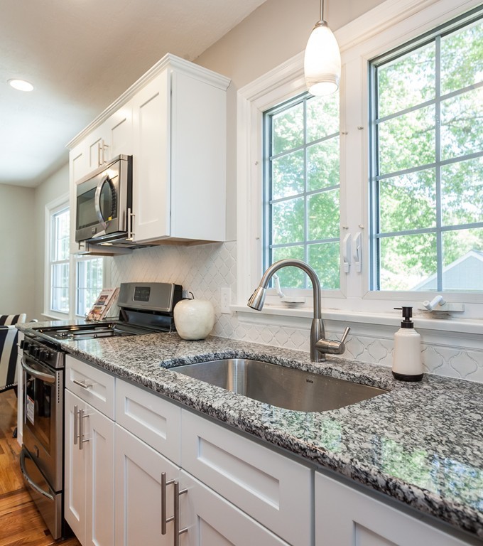 99 Sunnybrook Road Springfield, MA 01119 - Photo 2 of 30 a kitchen with stainless steel appliances granite countertop a sink a stove a dining table and chairs