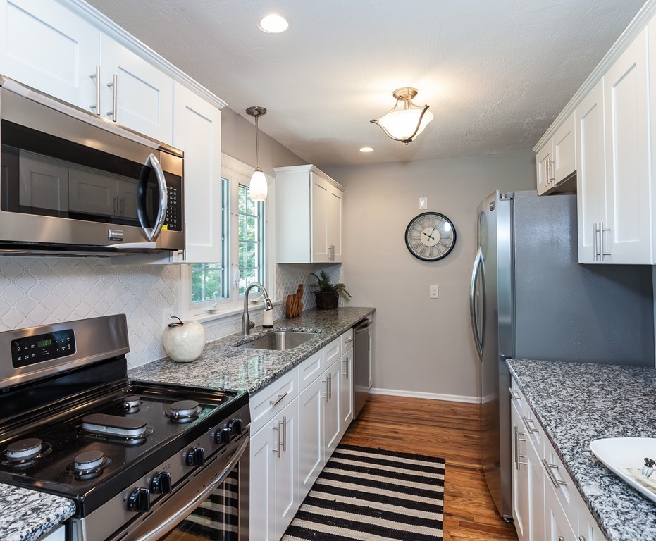 99 Sunnybrook Road Springfield, MA 01119 - Photo 4 of 30 a kitchen with stainless steel appliances granite countertop a stove a sink and a microwave