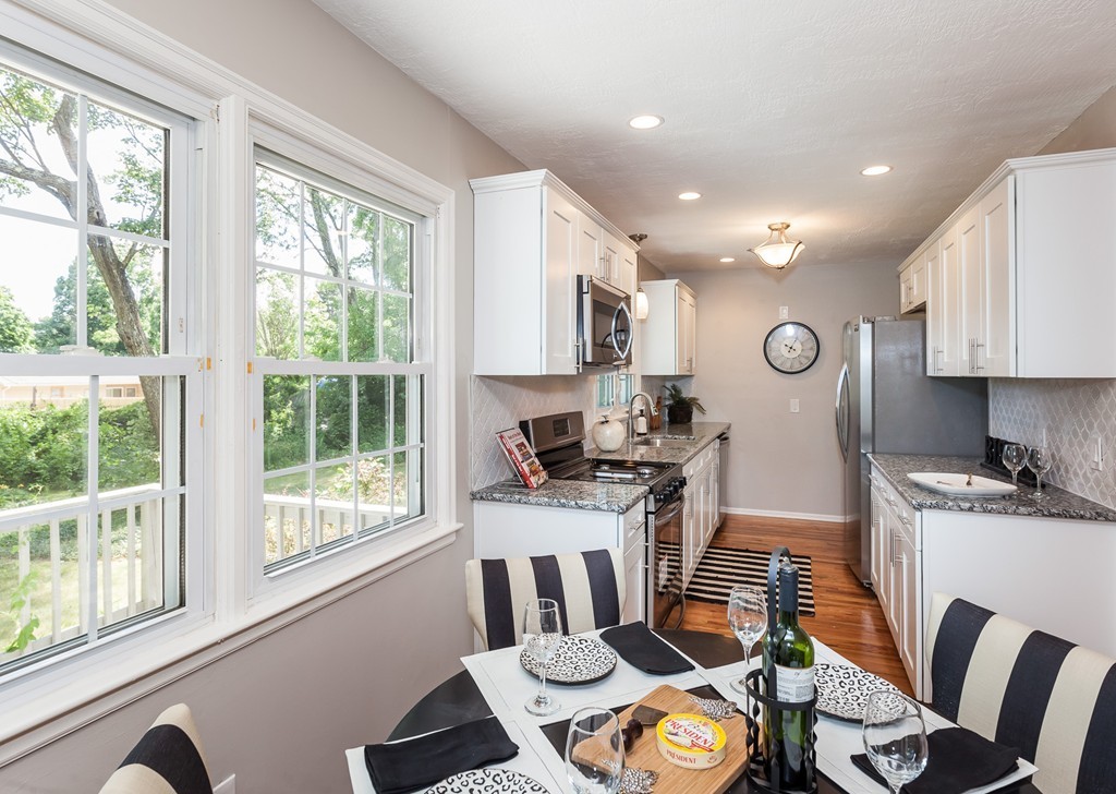 99 Sunnybrook Road Springfield, MA 01119 - Photo 6 of 30 a kitchen with stainless steel appliances granite countertop a stove top oven a sink dishwasher and cabinets with wooden floor