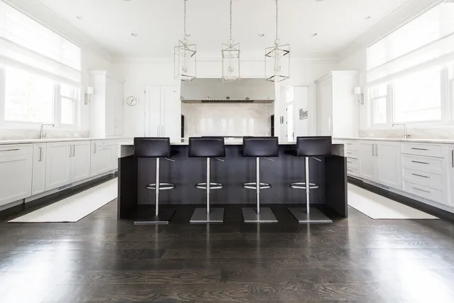 a large kitchen with cabinets and wooden floor