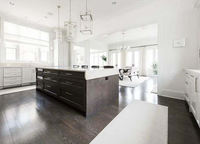 a large kitchen with kitchen island a large counter space a sink a window and stainless steel appliances