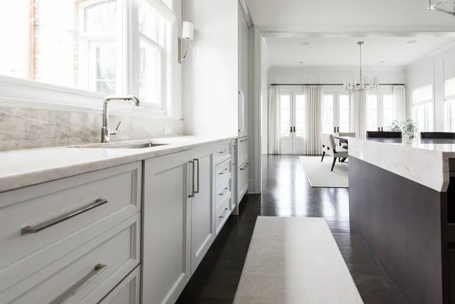 a en suite bathroom with a double vanity sink and a mirror