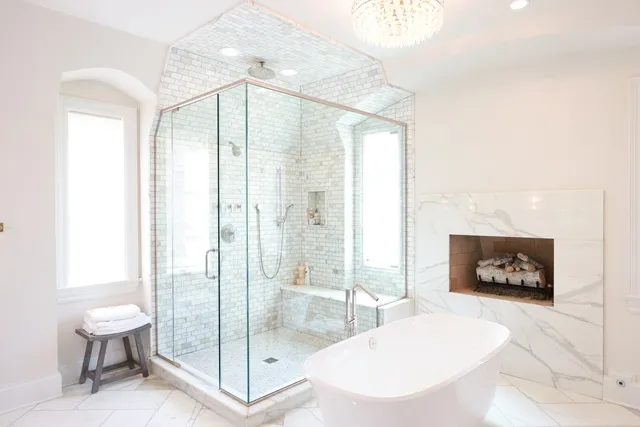 a spacious bathroom with a glass shower door and a sink